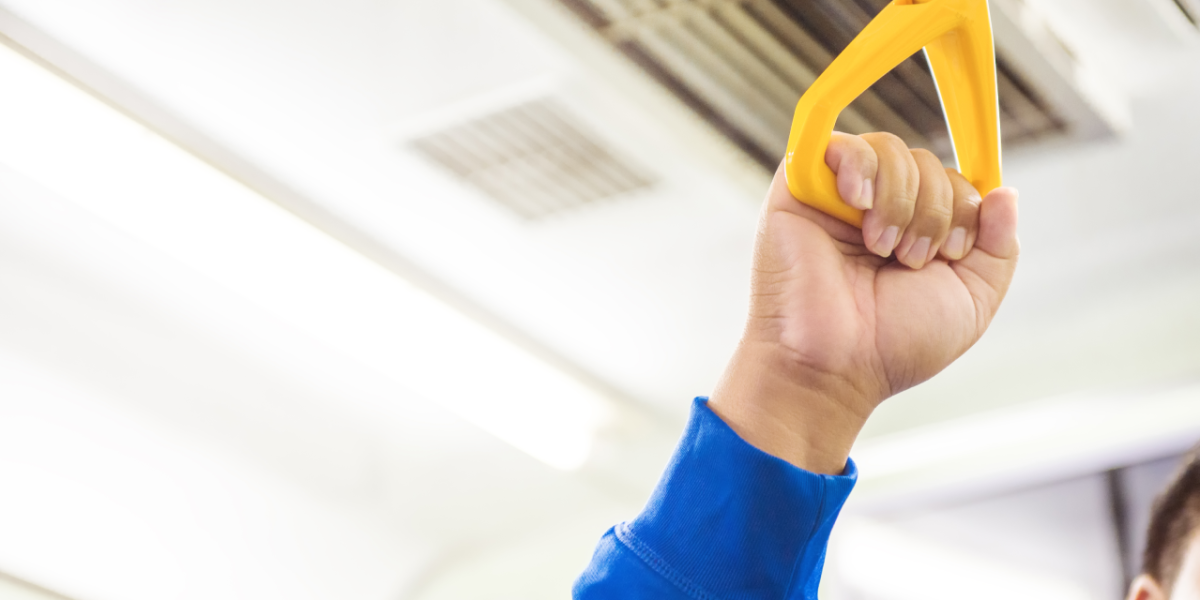 man-hand-holding-handle-on-the-train